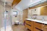 This stunning bathroom boasts a modern design with a touch of rustic charm.