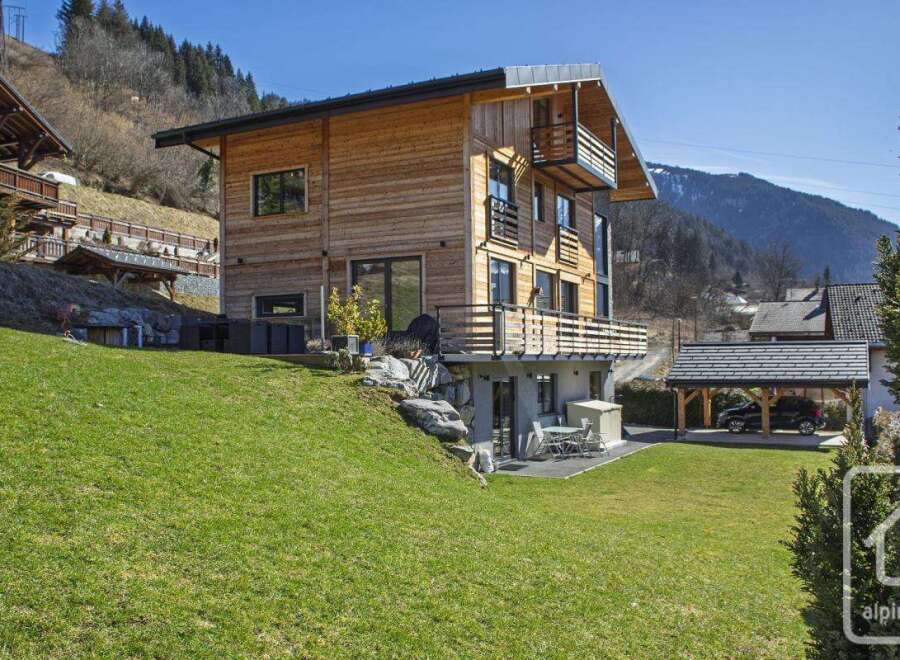 Discover this stunning wooden chalet nestled in a picturesque mountain setting.