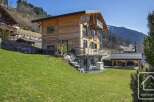 Discover this stunning wooden chalet nestled in a picturesque mountain setting.