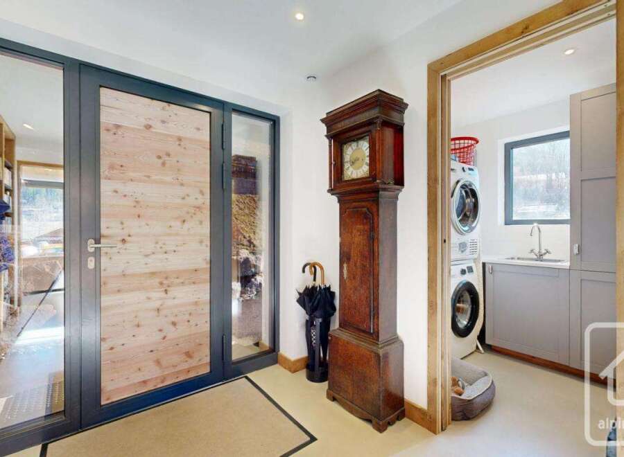 Step into this stunning property and be greeted by a grand entrance featuring a beautiful wooden door and a classic grandfather clock.