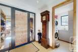 Step into this stunning property and be greeted by a grand entrance featuring a beautiful wooden door and a classic grandfather clock.