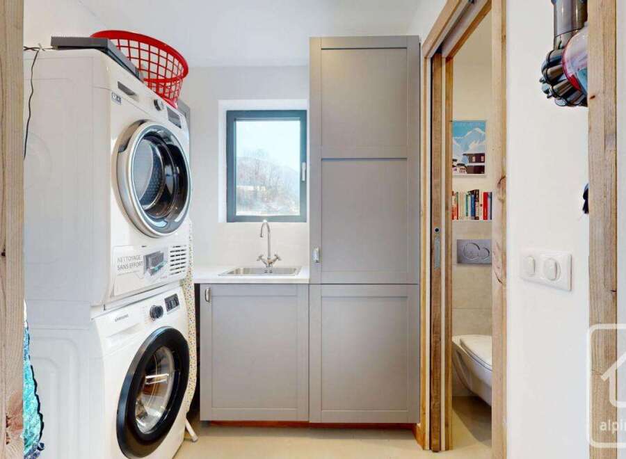 Discover the convenience of this well-equipped laundry room, featuring a modern washer and dryer setup.