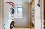 Discover the convenience of this well-equipped laundry room, featuring a modern washer and dryer setup.