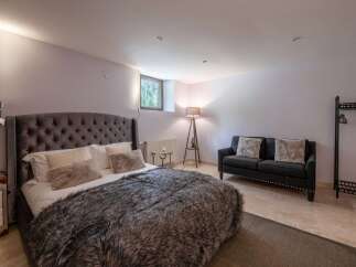 Luxurious bedroom with a plush king-size bed, complete with a cozy faux fur throw.