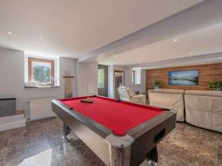 This stunning property boasts a luxurious game room featuring a professional pool table, perfect for entertaining guests.