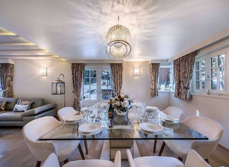 Luxurious chalet with stunning mountain views and a spacious dining area perfect for entertaining guests.