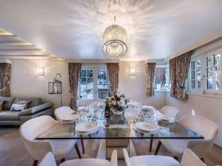 Luxurious chalet with stunning mountain views and a spacious dining area perfect for entertaining guests.