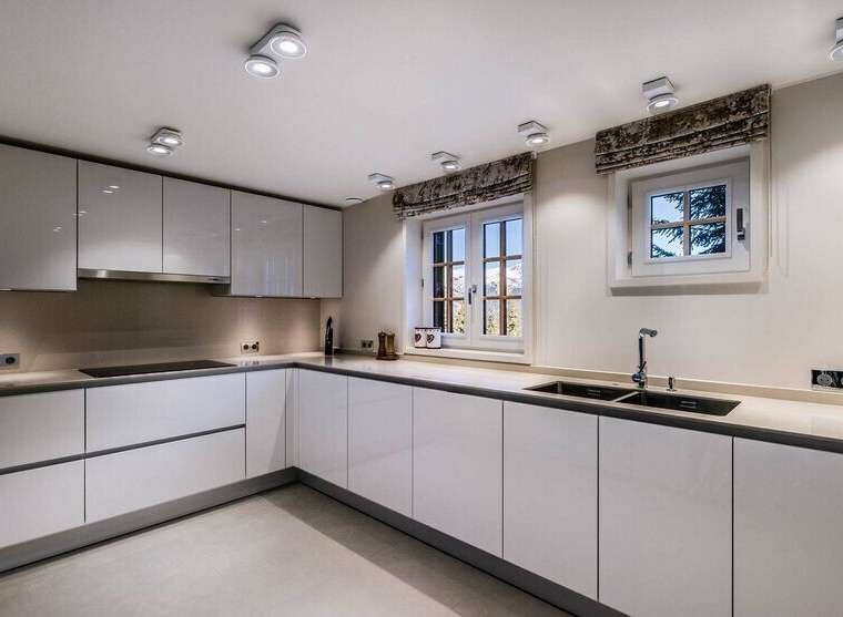 Modern kitchen with white cabinets and sleek countertops.