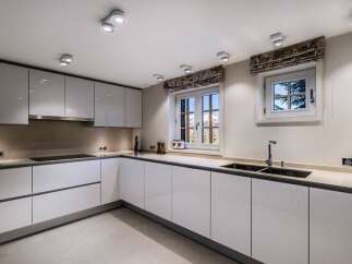 Modern kitchen with white cabinets and sleek countertops.