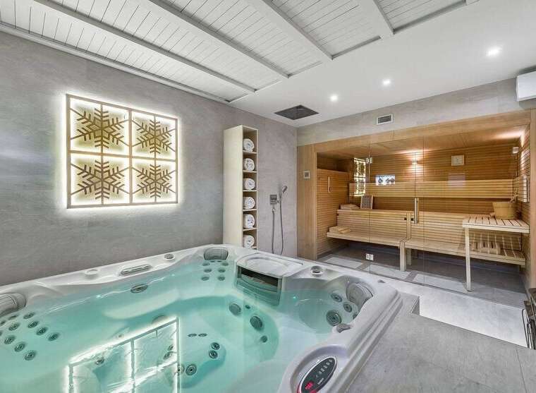 Indulge in ultimate relaxation with this stunning home spa featuring a luxurious jacuzzi and a modern sauna.