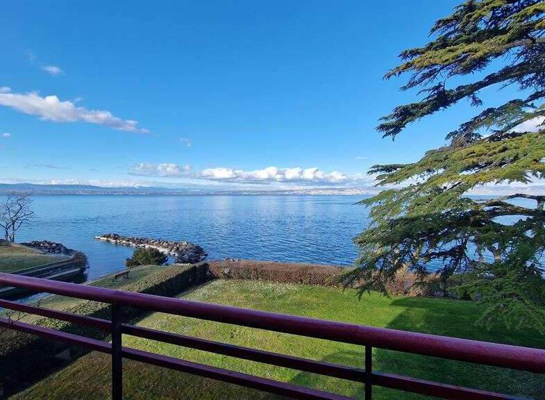 Enjoy breathtaking views from this stunning property! This home features a spacious balcony overlooking a serene lake and lush greenery.