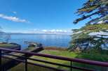 Enjoy breathtaking views from this stunning property! This home features a spacious balcony overlooking a serene lake and lush greenery.