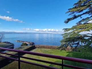 Enjoy breathtaking views from this stunning property! This home features a spacious balcony overlooking a serene lake and lush greenery.