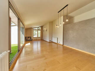 This stunning property boasts a spacious open-plan living area with gleaming hardwood floors and large sliding glass doors that lead to a private garden.
