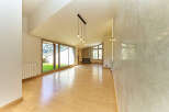 Stunning open-plan living space with hardwood floors and large windows offering scenic views.