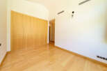 This stunning property boasts a spacious bedroom with gleaming hardwood floors and built-in wooden wardrobes, offering ample storage.