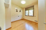 Light and airy bedroom with wood flooring and large window.