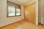 This bright and airy bedroom boasts beautiful hardwood floors and large built-in closets, providing ample storage space.