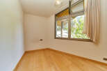 This bright and airy room features beautiful hardwood floors and large windows offering stunning views of the surrounding landscape.