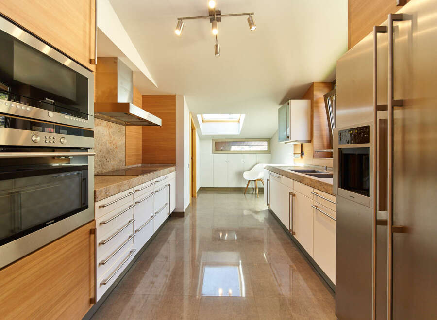 This stunning kitchen boasts modern appliances, sleek cabinetry, and a spacious layout.