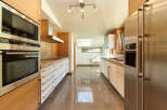 This stunning kitchen boasts modern appliances, sleek cabinetry, and a spacious layout.