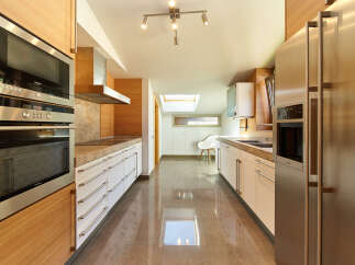 This stunning kitchen boasts modern appliances, sleek cabinetry, and a spacious layout.