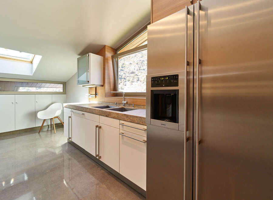 This stunning kitchen boasts modern cabinetry, sleek stainless steel appliances, and a spacious layout.