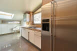 This stunning kitchen boasts modern cabinetry, sleek stainless steel appliances, and a spacious layout.
