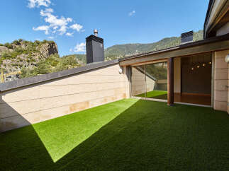 This stunning penthouse boasts a private rooftop terrace with artificial turf, perfect for outdoor relaxation.