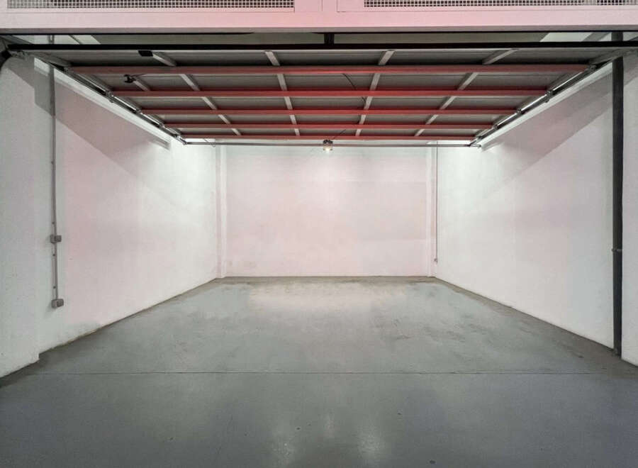 Spacious garage with high ceilings and ample floor space, perfect for parking and storage.