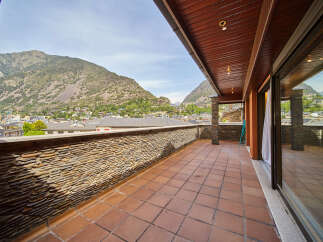 This stunning penthouse boasts a spacious terrace with breathtaking mountain views.