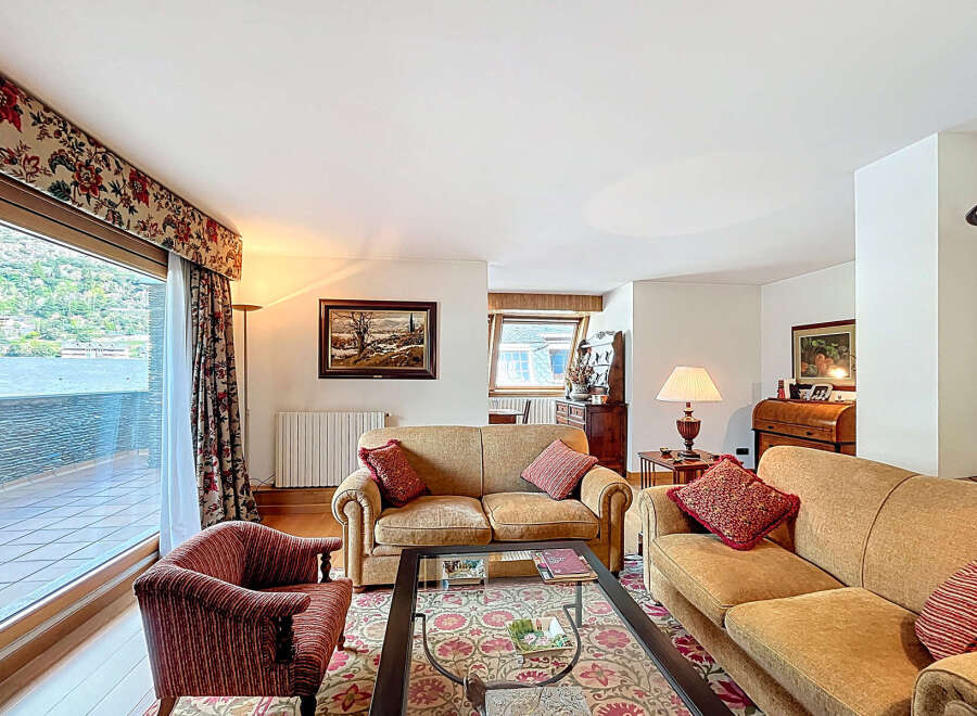 Luxurious apartment boasting stunning lake views from its expansive windows and private balcony.