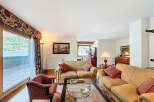 Luxurious apartment boasting stunning lake views from its expansive windows and private balcony.