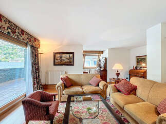 Luxurious apartment boasting stunning lake views from its expansive windows and private balcony.