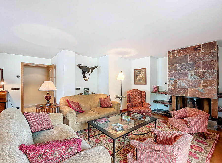 This stunning living room boasts a cozy fireplace, perfect for relaxing winter evenings.