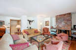 This stunning living room boasts a cozy fireplace, perfect for relaxing winter evenings.