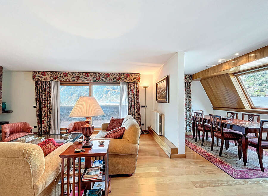 Lakefront living room with stunning views and a spacious dining area.
