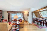 Lakefront living room with stunning views and a spacious dining area.
