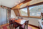 This stunning dining room boasts a breathtaking mountain view through its unique angled windows.
