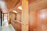 This stunning hallway boasts a beautiful wood-paneled ceiling and walls, creating a warm and inviting atmosphere.