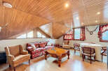 Charming attic apartment with wood-paneled ceilings and hardwood floors.