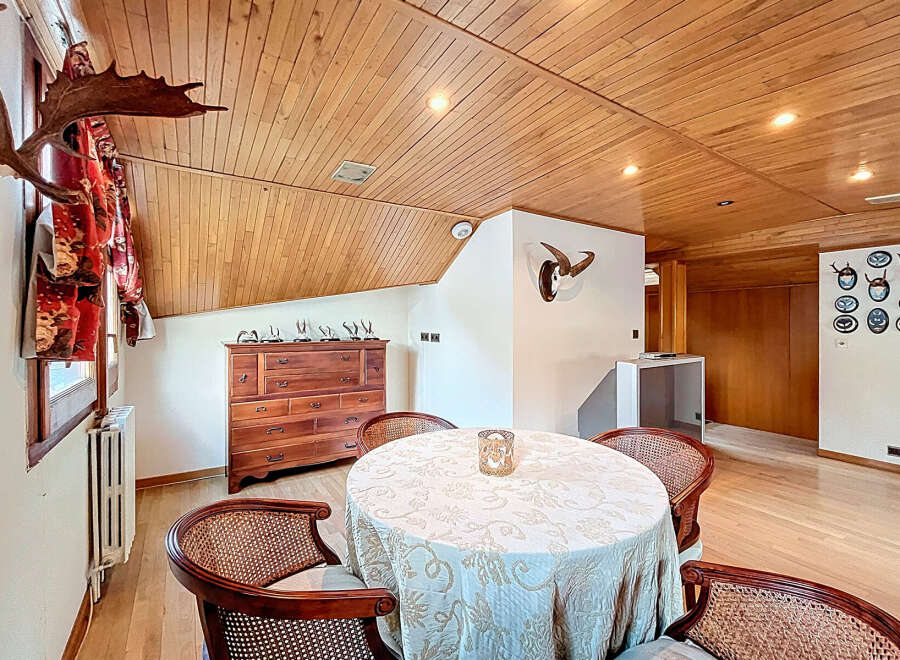 This stunning property boasts a unique dining area with a wooden ceiling and hardwood floors.