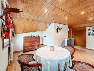 This stunning property boasts a unique dining area with a wooden ceiling and hardwood floors.