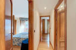 This stunning property boasts a spacious hallway with elegant wooden doors and flooring.