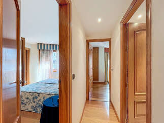 This stunning property boasts a spacious hallway with elegant wooden doors and flooring.