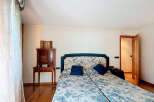 This beautiful bedroom features a comfortable double bed with a floral pattern, perfect for a relaxing night's sleep.