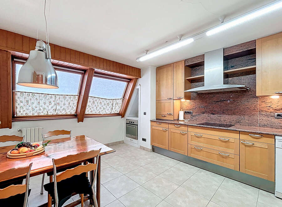 This stunning kitchen boasts a spacious layout with ample cabinetry, granite countertops, and high-end appliances.