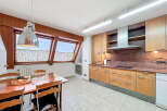 This stunning kitchen boasts a spacious layout with ample cabinetry, granite countertops, and high-end appliances.