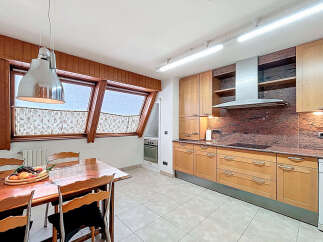 This stunning kitchen boasts a spacious layout with ample cabinetry, granite countertops, and high-end appliances.