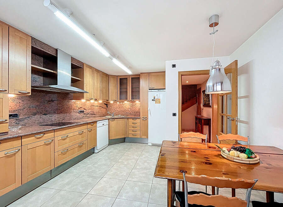 This stunning kitchen boasts beautiful light wood cabinets, granite countertops, and modern appliances.